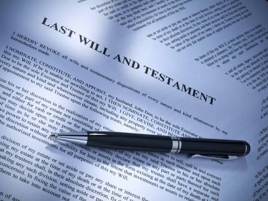 Probate Sales, Last Will and Testament with a pen on top Probate Sales