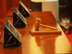 Successor Trustee, Three computer screens on a wood desk with a wood gavel Successor Trustee Duties