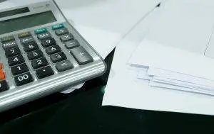 Beneficiaries, Calculator and legal documents on a desktop Beneficiaries, Consult with a CPA