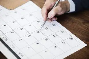 Trusts, Paper calendar on a desktop with a male hand holding a pen to the 16th Trusts, When does a trust end?