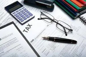Executor, Tax forms, papers, calculator, pen and calculator on a desk Executor, Filing Tax Returns